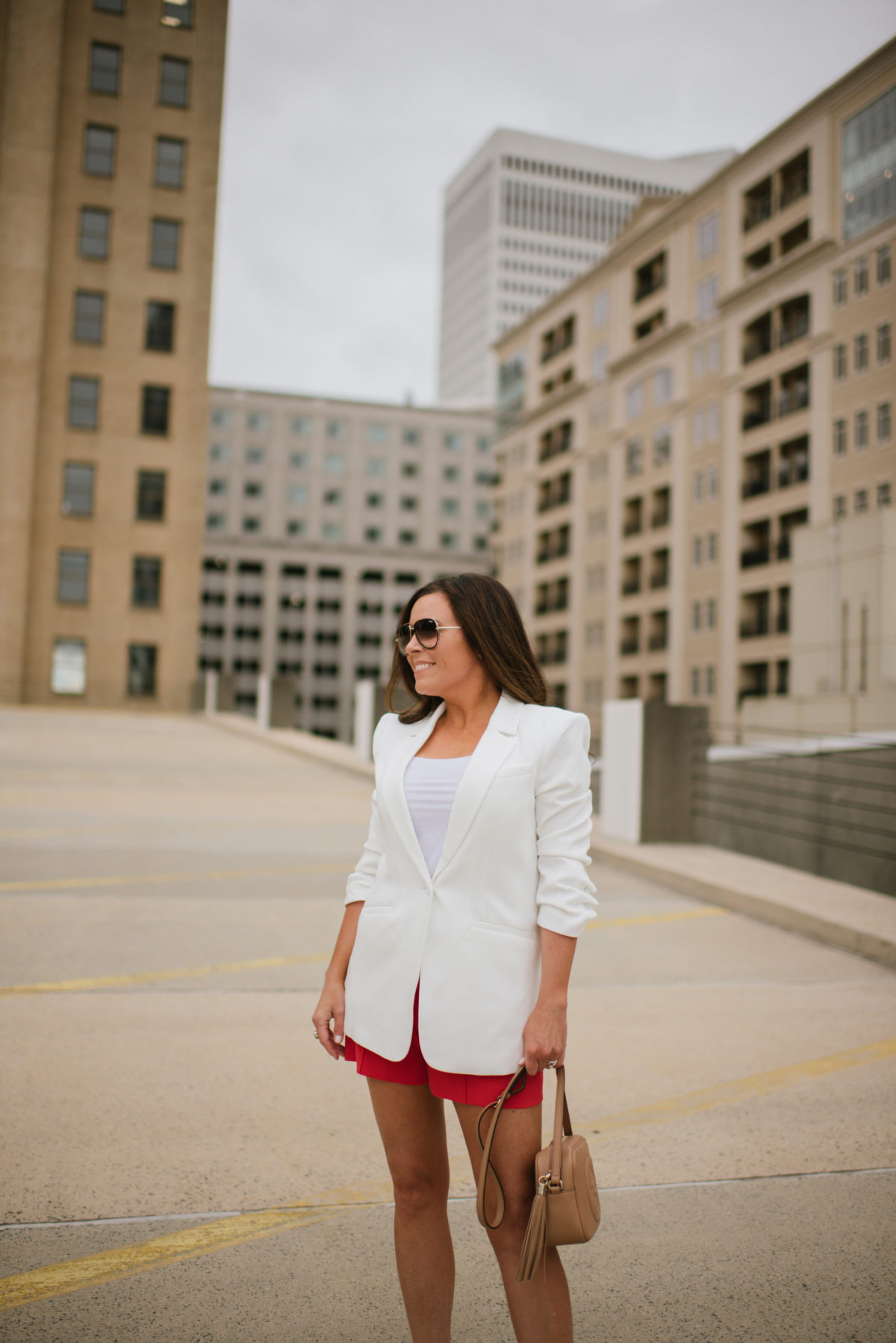 summer blazer styled with shorts, oversized sunglasses and statement bag
